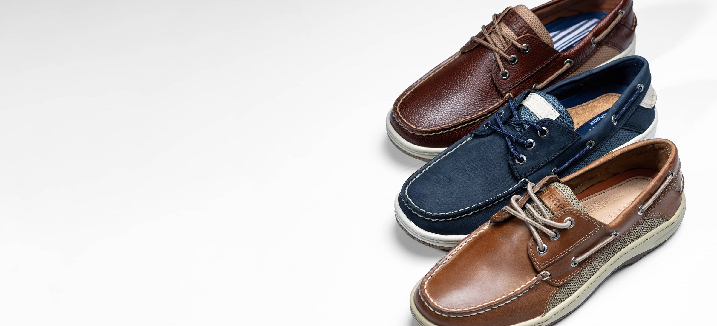 Three pairs of Sperry Billfish shoes: dark brown, navy blue, and tan, on a white background.